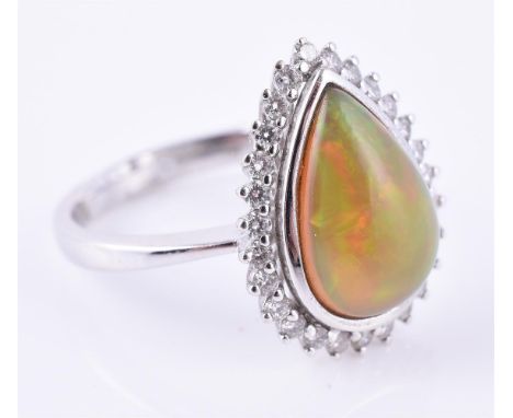 
	
		An opal and diamond cluster ring, the pear shaped opal cabochon within a surround of brilliant cut diamonds, 18 carat go