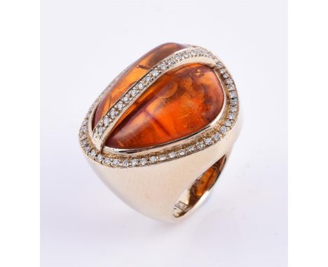 
	
		A diamond and pressed amber dress ring, the polished pressed amber within a surround of brilliant cut diamonds, and a ce