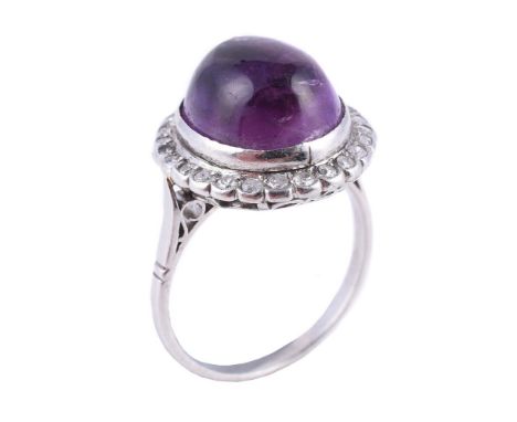 
	
		A diamond and amethyst dress ring, the oval cabochon amethyst within a surround of eight cut diamonds, approximately 0.2