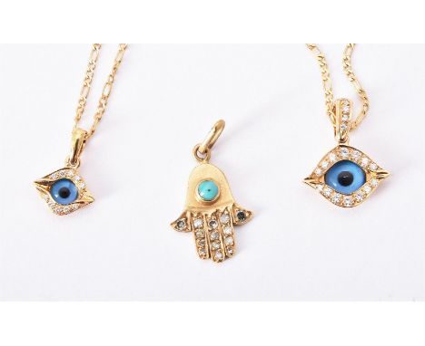 
	
		Two eye amulet pendants by Mouawad, the first with a paste eye with brilliant cut diamond accented lids, approximately 0