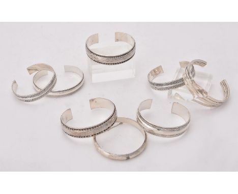 
	
		A collection of silver and silver coloured bangles, of various designs, stamped with London marks or 925, approximately 