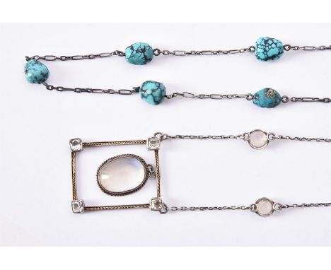 
	
		An Arts and Crafts moonstone and white stone pendant necklace, circa 1930, the rectangular frame shaped panel with facet