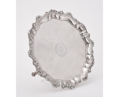 
	
		An Edwardian silver shaped circular salver by Sydney &amp; Co., Birmingham 1905, with a shell and scroll boarder, engrav