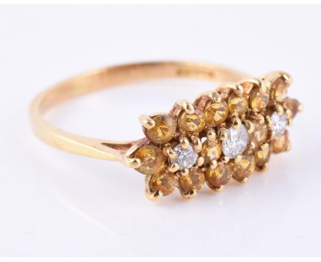 
	
		A diamond and yellow sapphire triple cluster ring, the graduated brilliant cut diamonds within a surround of yellow sapp