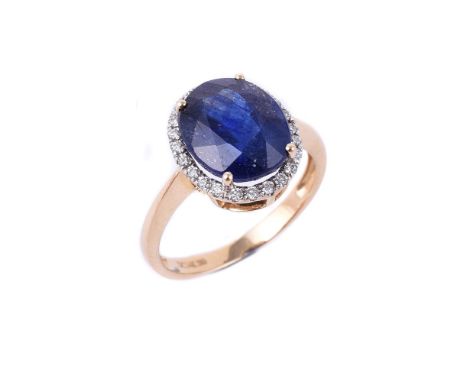 
	
		A diamond and synthetic sapphire dress ring, the oval cut synthetic sapphire within a surround of brilliant cut diamonds