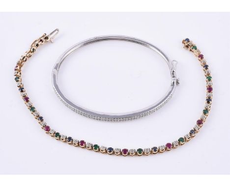 
	
		A 9 carat gold diamond hinged bangle, the front set with two rows of brilliant cut diamonds, approximately 0.52 carats, 