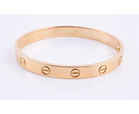 
	
		A two section gold coloured bangle, with screw head motifs, stamped 750, 30g 
		
		Condition Report: 
		This is not a Ca