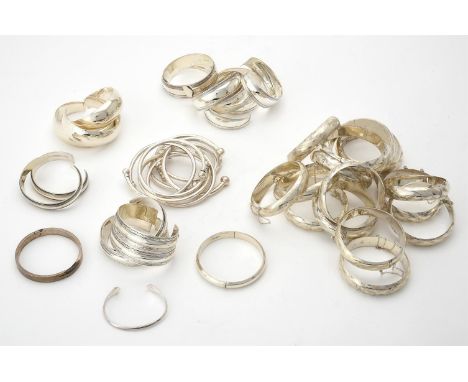
	
		A collection of silver and silver coloured bangles, of various designs, with London marks or stamped 925, approximately 