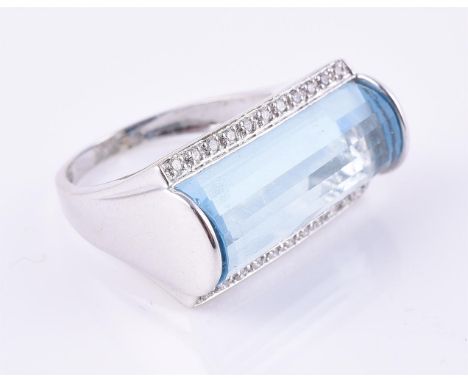 
	
		A diamond and blue topaz dress ring, the facetted shaped blue topaz with brilliant cut diamond borders, approximately 0.