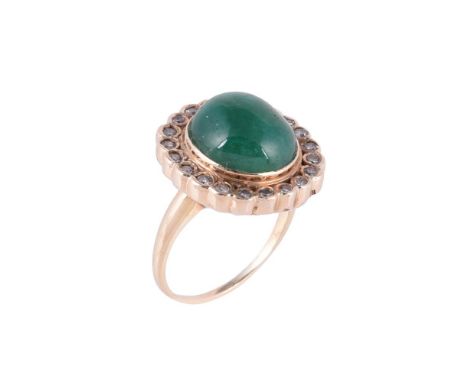 
	
		An emerald and diamond cluster dress ring, the central oval cabochon emerald within a surround of eight cut diamonds, ap