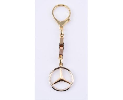 
	
		An Italian three colour gold key ring and fob, the fob drop designed a the Mercedes badge, stamped 750 with Italian cont