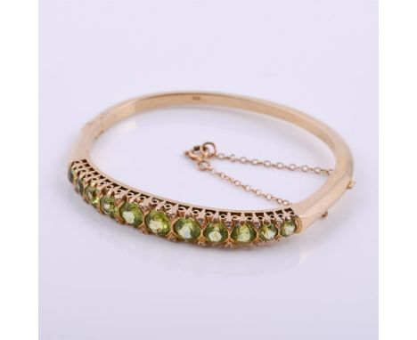 
	
		A 9 carat gold peridot hinged bangle, with diamond point accents, stamped 9ct, inner width 5.6cm inner width, 23.2g gros