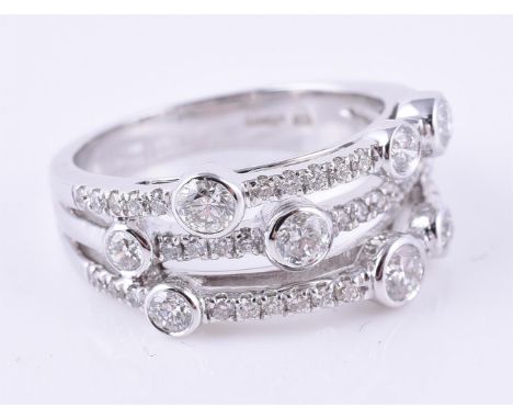 
	
		An 18 carat gold diamond three row ring, the three rows of graduated brilliant cut diamonds, approximately 0.71 carats t