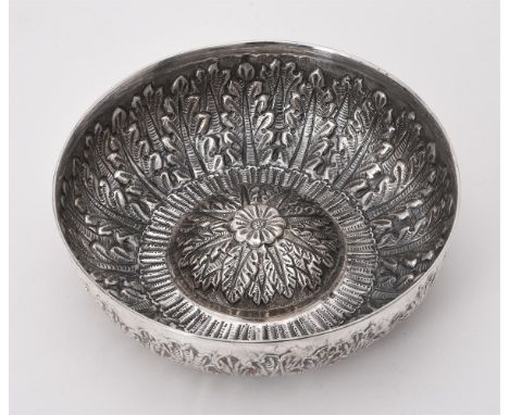 
	
		An Islamic silver coloured bowl, unmarked, chased with an acanthus band and a flower to the centre, 20cm (8in) diameter,