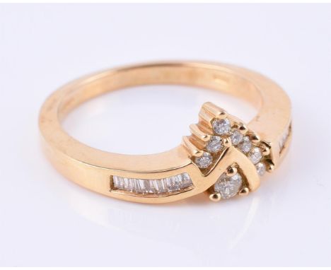 
	
		An 18 carat yellow gold diamond dress ring, set with brilliant and baguette cut diamonds, approximately 0.20 carats tota