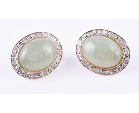
	
		A pair of jadeite and diamond cluster ear clips, the central oval jadeite cabochons set within a surround of eight cur d