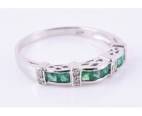 
	
		An emerald and diamond band ring, set with square cut emeralds and eight cut diamonds, stamped K18, finger size M, 2.2g 