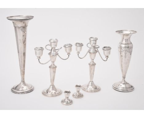 
	
		A pair of American silver coloured three light candelabra by Gorham, with urn shaped capitals, tapering stems and on cir