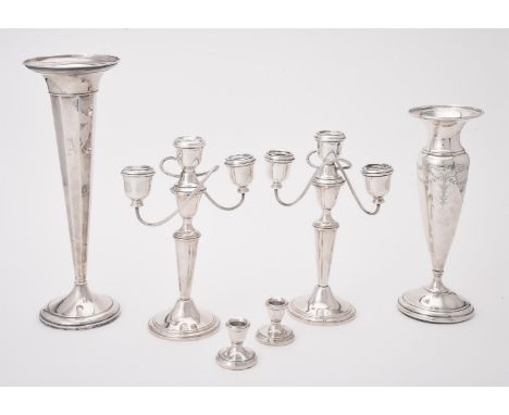 
	
		A pair of American silver coloured three light candelabra by Gorham, with urn shaped capitals, tapering stems and on cir