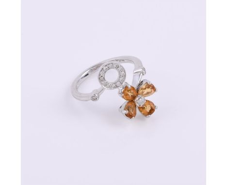 
	
		A citrine and diamond dress ring, the crossover band terminating with a citrine flower head and a diamond set hoop, 18 c