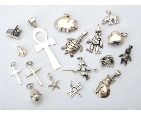 
	
		A collection of silver coloured pendants, to include turtles, pigs, crosses, cats, articulated bears, and ankh pendants,