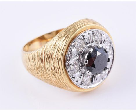 
	
		A diamond and black diamond cluster dress ring, the black diamond estimated to weigh 1.15 carats, within a surround of b