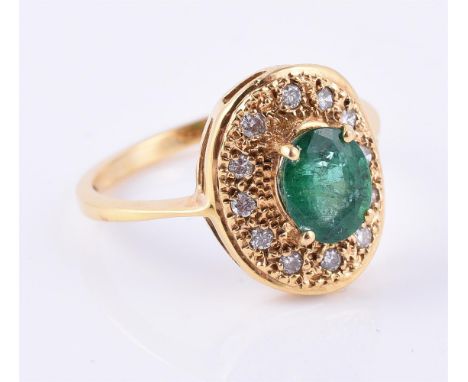 
	
		An emerald and diamond cluster ring, the oval mixed cut emerald claw set above a surround of pave set brilliant cut diam