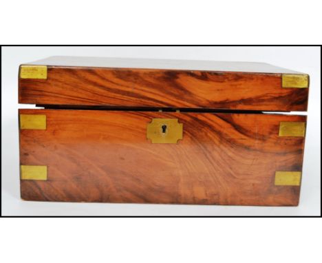 A 19th century Victorian walnut writing slope having a dual barrel lock with brass edge work , monogrammed cartouche panel to