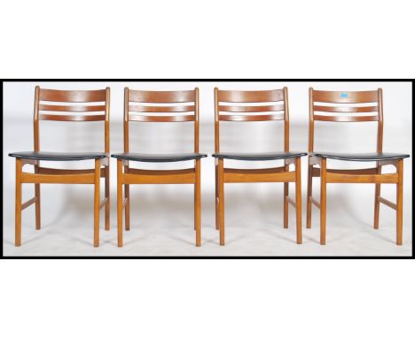 A set of 4 Danish ladder back dining chairs with black leather seat pads and teak frames with stamps for Denmark underneath. 