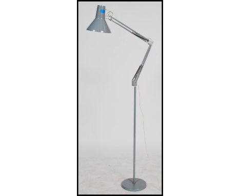 A vintage 20th century retro industrial Danish anglepoise standard lamp raised on a circular grey base with tubular stem and 