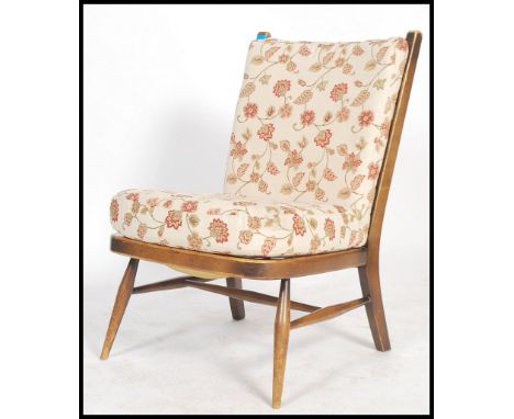 An Ercol ' Windsor ' pattern beech wood open framed chair - armchair. Raised on turned legs with webbed seat and back rest ha