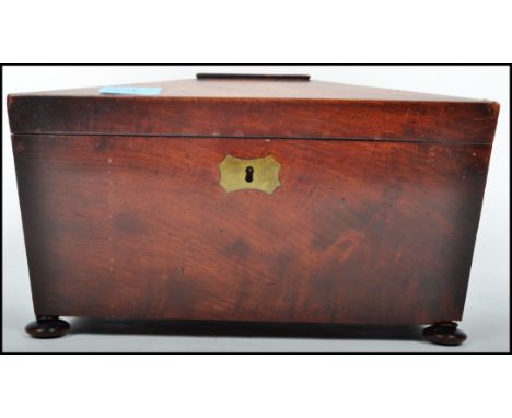 A 19th century Regency rosewood caddy box. Of large form with hinged sarcophagus top over open storage within