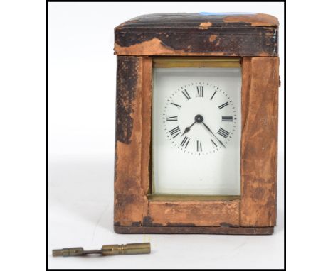 A late 19th century French  century brass cased carriage clock, in a leather carrying case, with key. Measurements: 14 cm hig