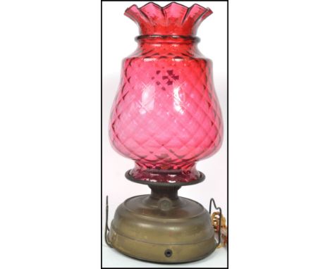 A large 19th century Victorian cranberry glass shade on the form of a pineapple having a flared scalloped rim surmounting a c