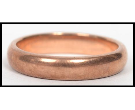 A 9ct gold band ring of usual simple form, bearing makers marks for X K, weighing xxg and measuring size ?