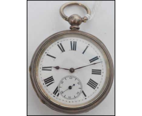 An early 20th century open faced silver pocket watch having key wind movement, enamel faced with roman numeral chapter ring a