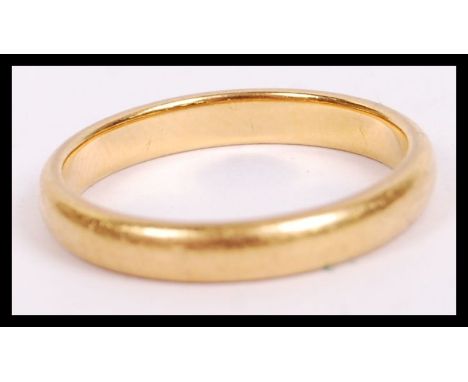 An 22ct hallmarked gold ring of usual simple form bearing Birmingham assay marks. Weighs 3.8g and size M.5 