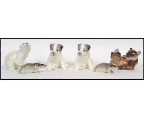 A group of six mid century made in USSR ceramic figurines to include a pair of terrier dogs a polar bear, a brown bear cub an