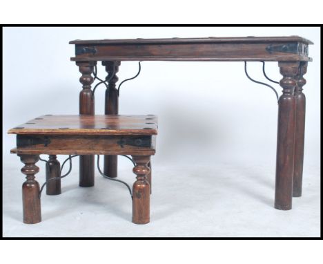 A vintage hard wood console table console tale and coffee table raised on long cylindrical legs with studded tops. Measures 7