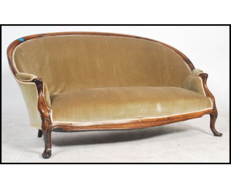 A good 19th century Victorian sofa settee being raised on mahogany cabriole legs with show wood frame having arched back and 