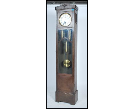 A good 1920's large Westminster chiming longcase clock with large silvered dial over glass window trunk having brass weights 