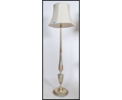 A contemporary silvered standard lamp of reeded form with the terraced base and good shade ( see illustrations ). Measurement