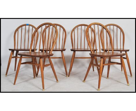 A set of six Ercol spindle back dining chairs on tapered legs in the blonde colourway. Measures 10cms x 43cms x 41cms.