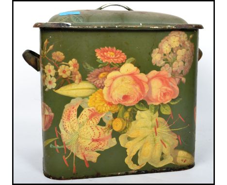 A vintage 20th century retro enamel bread bin having a green ground with floral decoration.