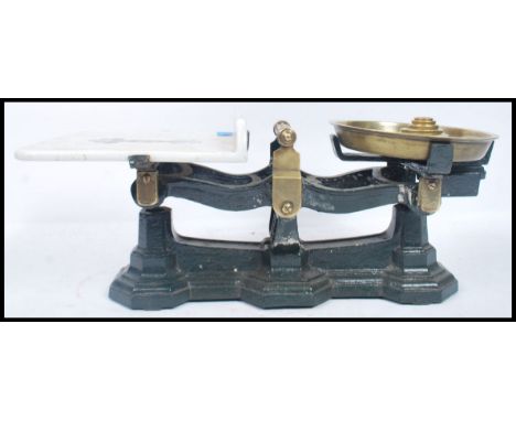 A set of late Victorian Parnell & Son Bristol cast metal and ceramic weighing scales raised on three octagonal plinths with c