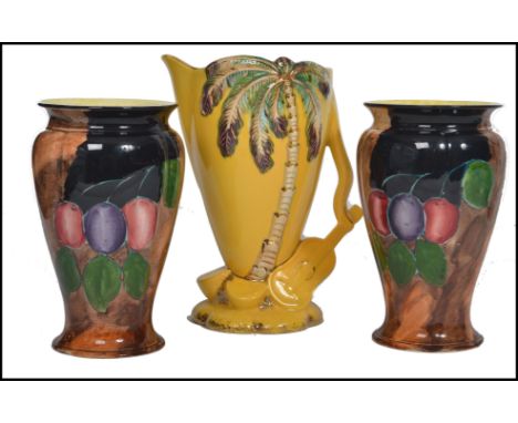 A pair of H and K Tunstall seasonal vases of tapering form with waisted and flared rims along with a Beswick Hawaiian pitcher