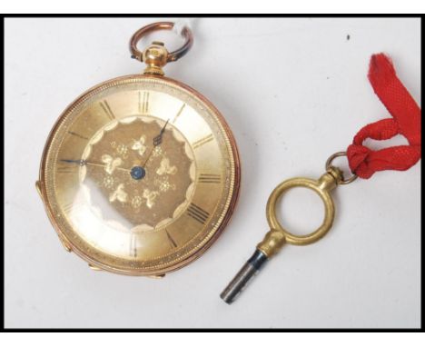 An 18ct gold early 20th century open faced fob / pocket watch with engine turned dial having faceted hands  with roman numera