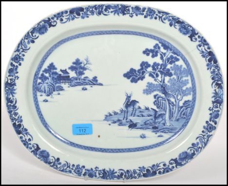 An early 19th century circa 1810 Chinese blue and white ceramic charger depicting a house to the background with a Stag and a