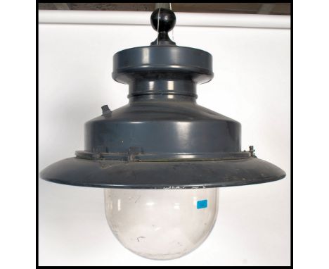 A vintage style 20th century industrial street lamp by Urbis. The cast metal pendant shade sitting above a large glass dome c