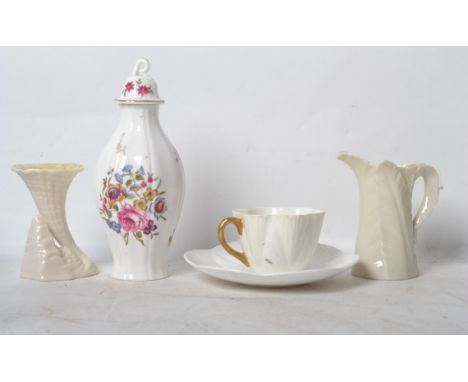 A group of ceramics to include a Belleek trumpet vase, Worcester lidded vase, a Shelley cup and saucer and a Worcester leaf e